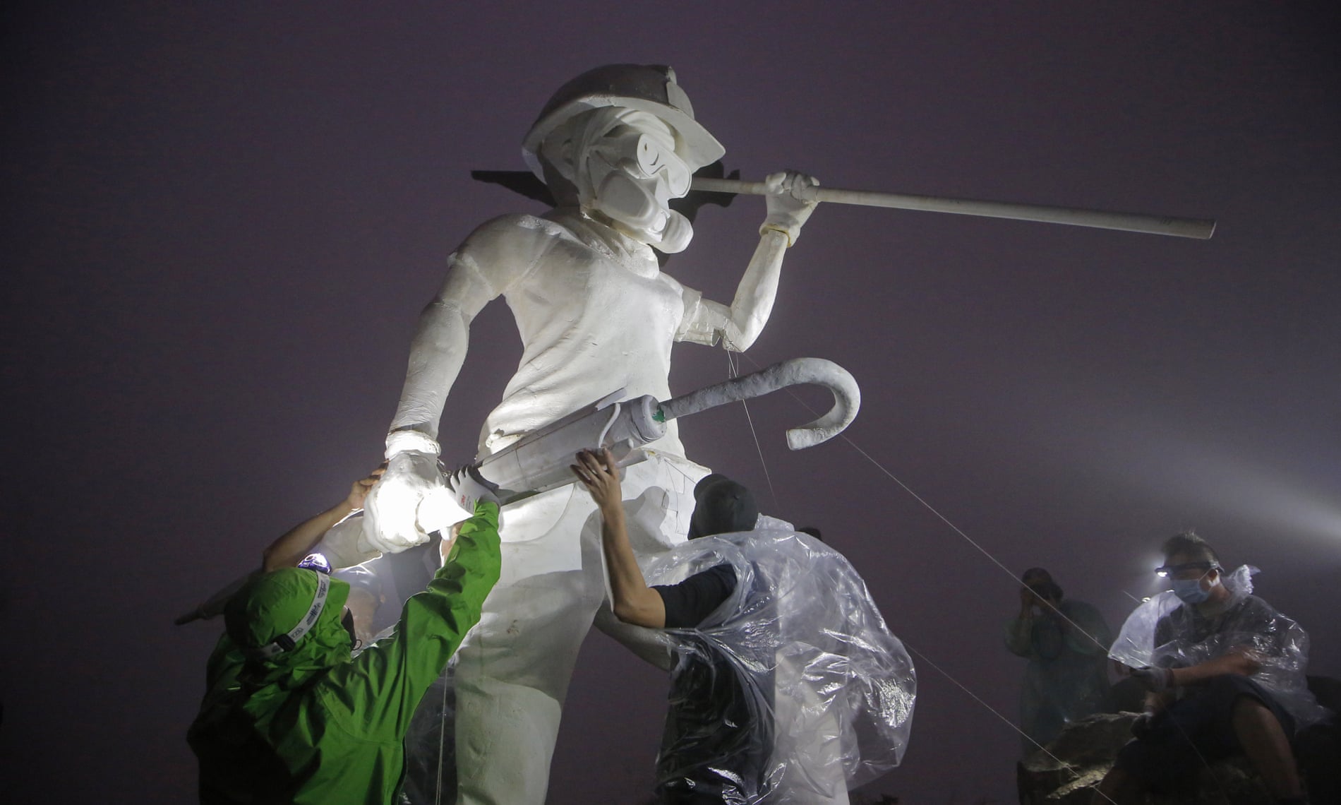 مجسمه ۴ متری بانوی آزادی با ماسک و کلاه ایمنی در هنگ کنگ