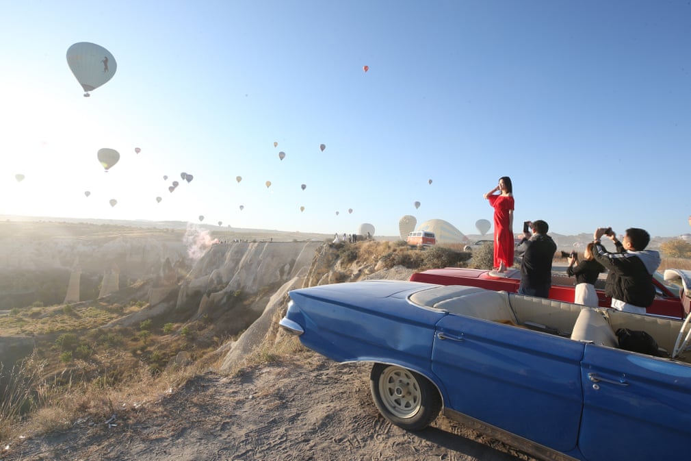 گردشگران در حال عکس و فیلم گرفتن از بالن‌ها در ترکیه